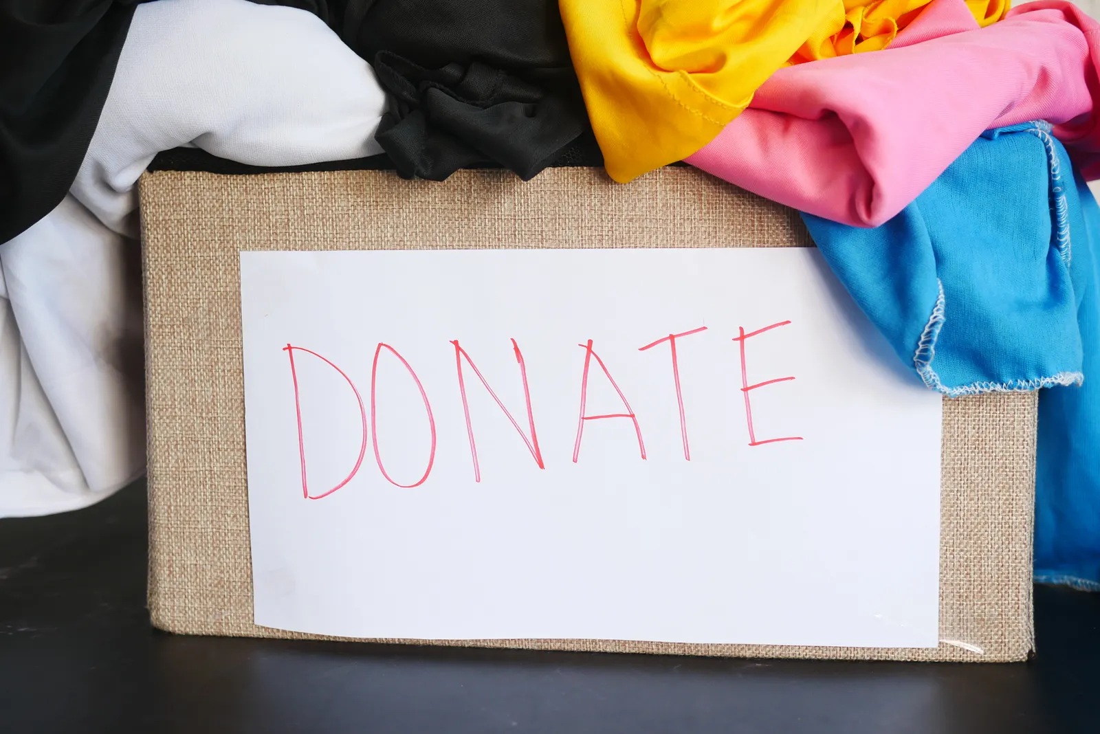 A donation box filled with clean clothing